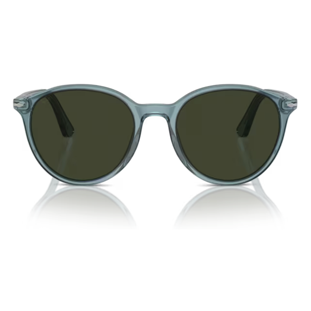 Occhiali da sole Komono modello Lennon, colore Blue Tortoise, forma rotonda con montatura trasparente blu e lenti scure.