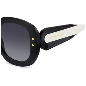 Occhiali da sole Carolina Herrera, montatura ovale nera con dettagli dorati e aste bianche.