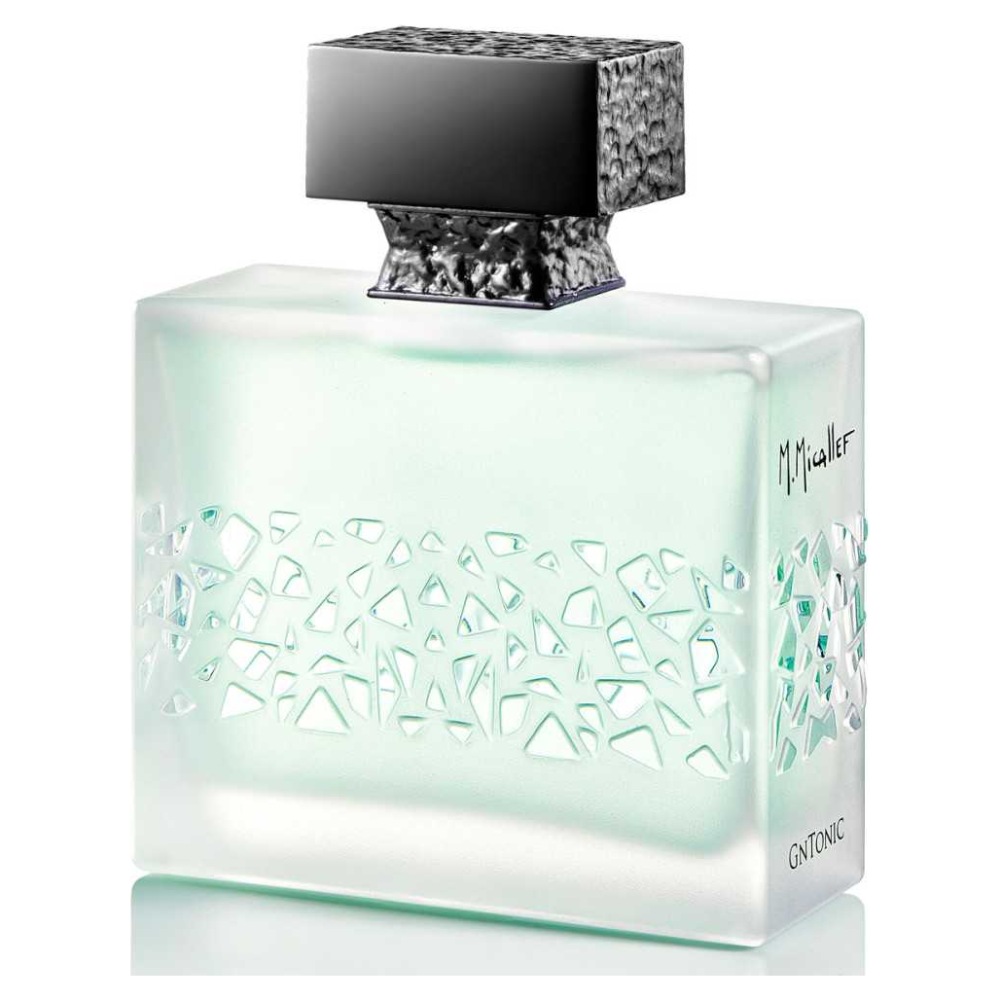 Bottiglia di profumo M. Micallef, design elegante con intagli geometrici, tappo nero, vetro trasparente.