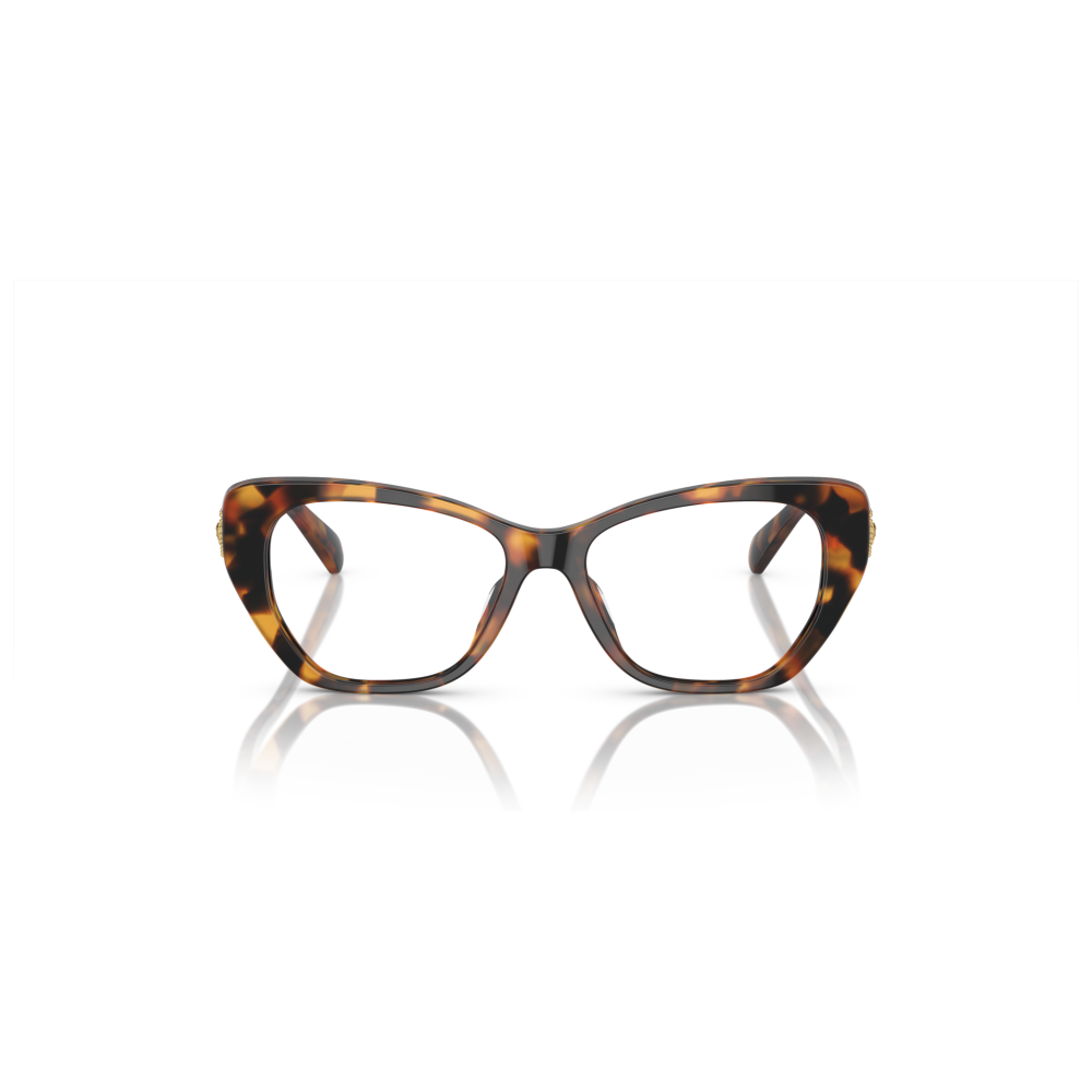 Occhiali cat-eye tartarugati. Montatura spessa marrone con motivo maculato. Marchio non visibile.