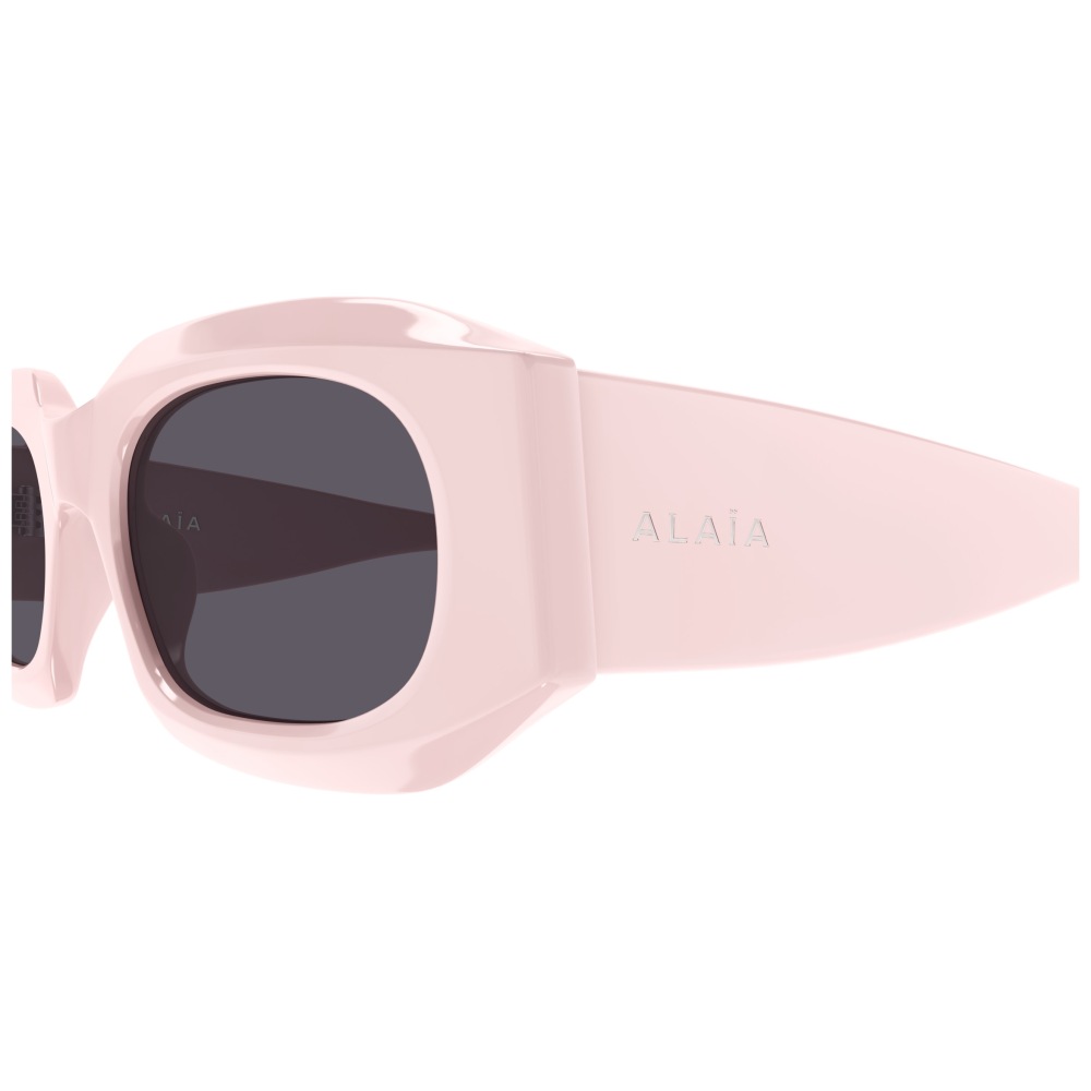 Occhiali Alaïa, montatura rettangolare rosa chiaro, design audace e moderno.