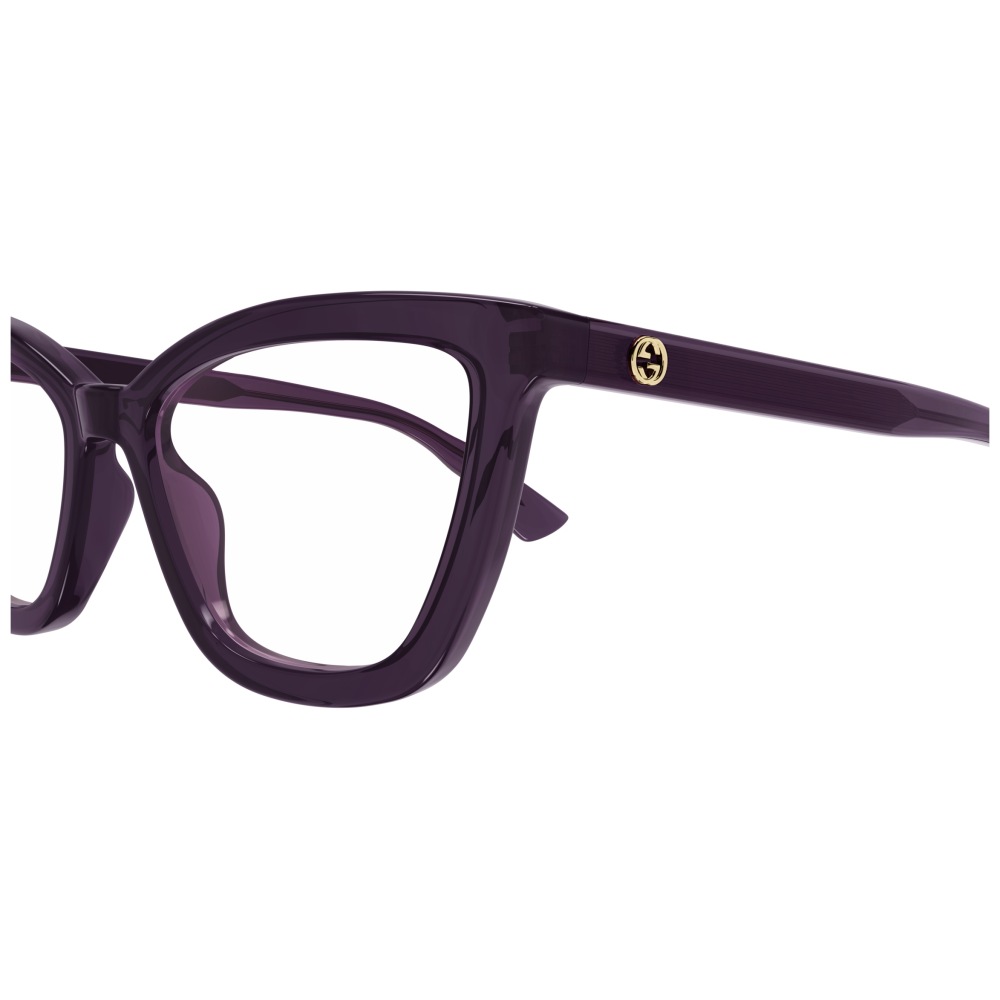 Occhiali Gucci, montatura spessa viola scuro, forma a occhio di gatto, dettaglio logo dorato sulle aste.
