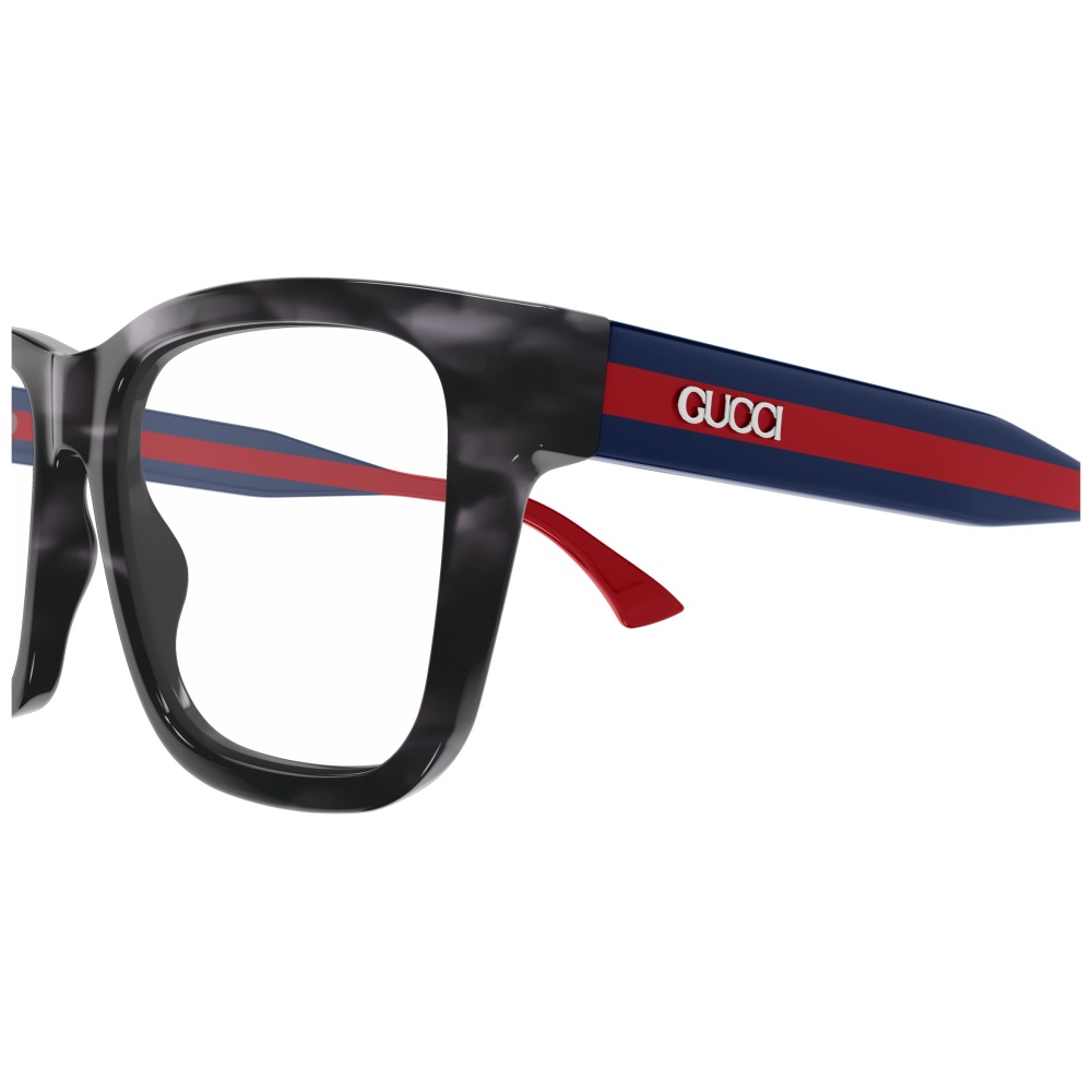 Occhiali Gucci, montatura squadrata nera marmorizzata, aste blu con banda rossa e logo bianco.